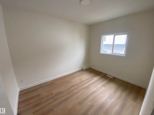 Spare room with light wood-style floors and baseboards - 5421 60 Avenue, Vegreville, AB - Indoor Photo Showing Other Room
