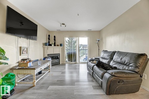 344 2096 Blackmud Creek Drive, Edmonton, AB - Indoor Photo Showing Living Room With Fireplace