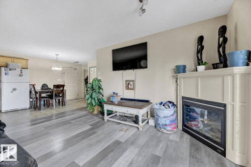 344 2096 Blackmud Creek Drive, Edmonton, AB - Indoor Photo Showing Living Room With Fireplace