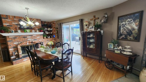 5307 Ravine Drive, Elk Point, AB - Indoor Photo Showing Dining Room With Fireplace