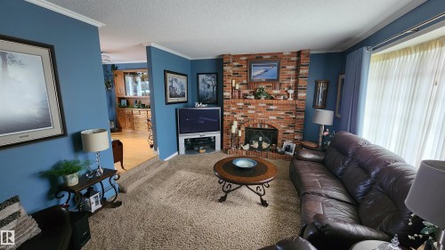 5307 Ravine Drive, Elk Point, AB - Indoor Photo Showing Living Room With Fireplace