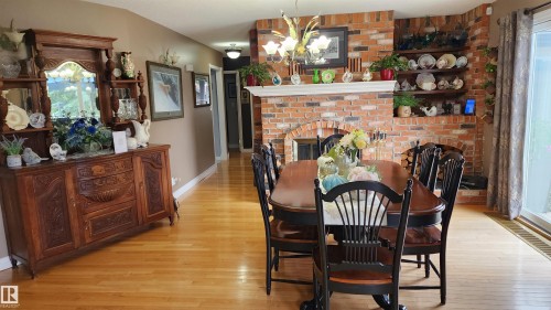5307 Ravine Drive, Elk Point, AB - Indoor Photo Showing Dining Room With Fireplace