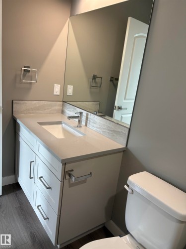 Bathroom with vanity and dark wood-type flooring - 7413 44 Avenue, Camrose, AB - Indoor Photo Showing Bathroom