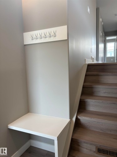 Staircase featuring wood finished floors and baseboards - 7413 44 Avenue, Camrose, AB - Indoor Photo Showing Other Room