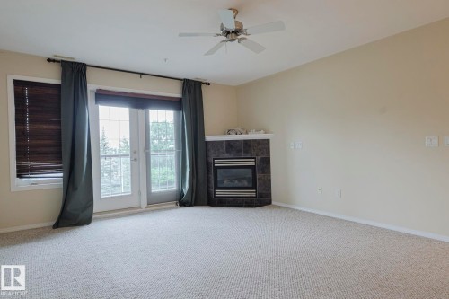 409 261 Youville Drive, Edmonton, AB - Indoor Photo Showing Other Room With Fireplace