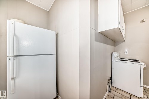 Kitchen with white appliances, white cabinetry, and light tile patterned floors - 12605 107 Avenue, Edmonton, AB - Indoor