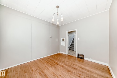 Dining room with hardwood / wood-style flooring and stairs - 12605 107 Avenue, Edmonton, AB - Indoor Photo Showing Other Room
