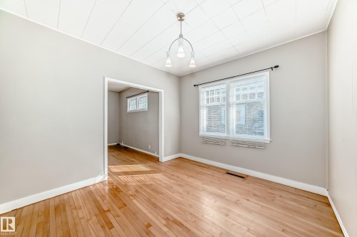 Dining room with light wood-style floors and baseboards - 12605 107 Avenue, Edmonton, AB - Indoor Photo Showing Other Room