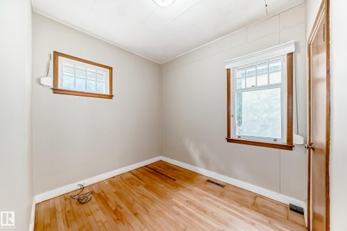 Bed room featuring wood-type flooring and healthy amount of natural light - 12605 107 Avenue, Edmonton, AB - Indoor Photo Showing Other Room