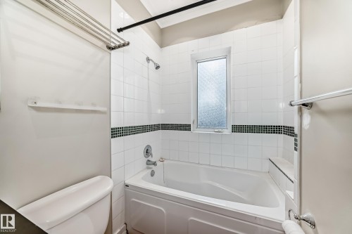 Bathroom featuring tub / shower combination and toilet - 12605 107 Avenue, Edmonton, AB - Indoor Photo Showing Bathroom