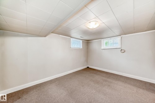 Below grade area with carpet and a drop ceiling - 12605 107 Avenue, Edmonton, AB - Indoor Photo Showing Other Room