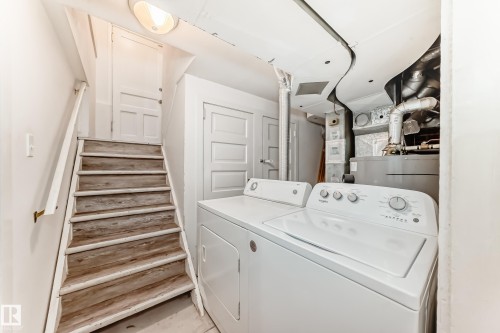 Laundry area with washing machine and dryer and water heater - 12605 107 Avenue, Edmonton, AB - Indoor Photo Showing Laundry Room