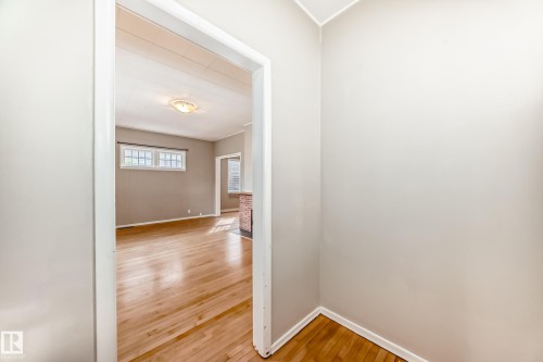 Hall with light wood finished floors and baseboards - 12605 107 Avenue, Edmonton, AB - Indoor Photo Showing Other Room