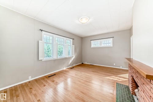 Living room featuring light wood-style floors and baseboards - 12605 107 Avenue, Edmonton, AB - Indoor Photo Showing Other Room