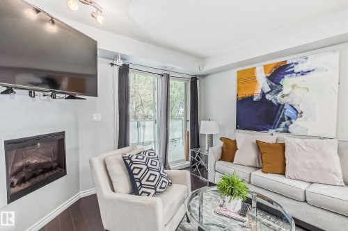 115 10118 106 Avenue, Edmonton, AB - Indoor Photo Showing Living Room With Fireplace