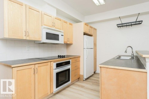 106 8619 111 Street, Edmonton, AB - Indoor Photo Showing Kitchen With Double Sink