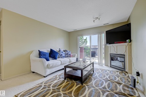 452 2096 Blackmud Creek Drive, Edmonton, AB - Indoor Photo Showing Living Room With Fireplace