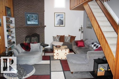 28 Silver Beach, Rural Wetaskiwin County, AB - Indoor Photo Showing Living Room With Fireplace