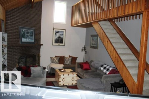 28 Silver Beach, Rural Wetaskiwin County, AB - Indoor Photo Showing Living Room With Fireplace