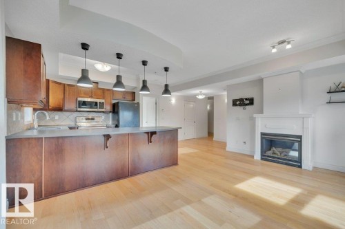 306 10232 115 Street, Edmonton, AB - Indoor Photo Showing Kitchen With Fireplace