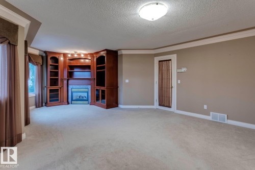 957 Hollingsworth Bend, Edmonton, AB - Indoor Photo Showing Other Room With Fireplace