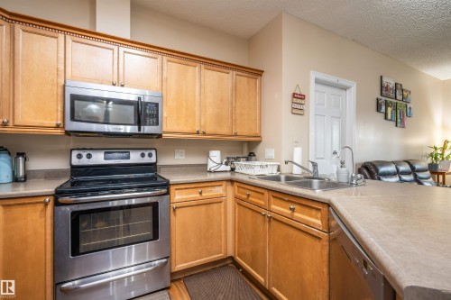 #117 226 Macewan Road Sw, Edmonton, AB - Indoor Photo Showing Kitchen With Double Sink