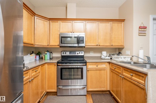 #117 226 Macewan Road Sw, Edmonton, AB - Indoor Photo Showing Kitchen With Double Sink