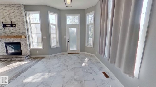 29 Rue Bouchard, Beaumont, AB - Indoor Photo Showing Other Room With Fireplace