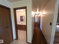 Corridor featuring light floors and a sink - 