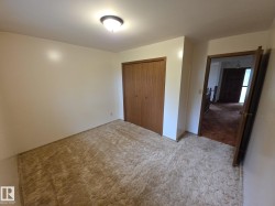 Unfurnished bedroom with carpet floors and a closet - 