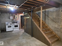 Unfinished below grade area featuring stairway - 