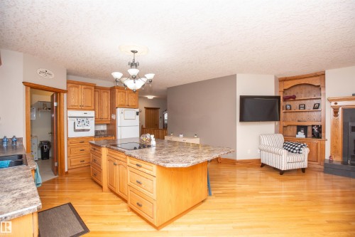 #2-26412 Twp Rd 594, Rural Westlock County, AB - Indoor Photo Showing Kitchen With Fireplace