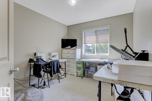 bedroom currently used as an Office with carpet floors and a textured ceiling - 18 5281 Terwillegar Boulevard, Edmonton, AB - Indoor Photo Showing Office