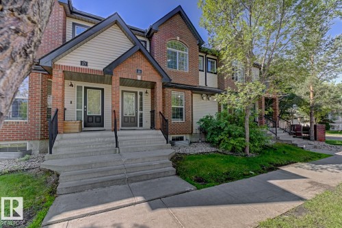 View of front facade with brick siding and covered porch - 18 5281 Terwillegar Boulevard, Edmonton, AB - Outdoor With Facade