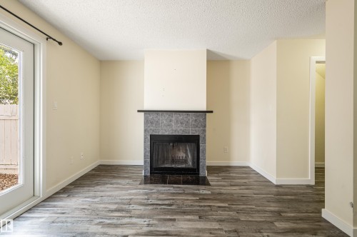105 14707 53 Avenue, Edmonton, AB - Indoor Photo Showing Living Room With Fireplace