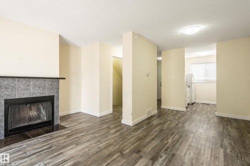 105 14707 53 Avenue, Edmonton, AB - Indoor Photo Showing Living Room With Fireplace
