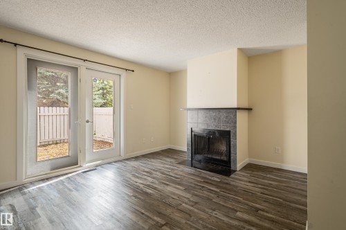 105 14707 53 Avenue, Edmonton, AB - Indoor Photo Showing Living Room With Fireplace