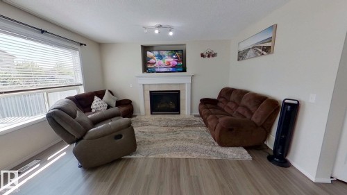 3311 21 Street, Edmonton, AB - Indoor Photo Showing Living Room With Fireplace