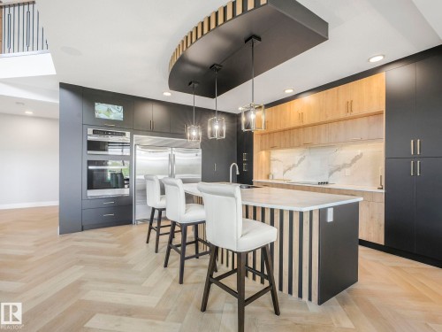 Kitchen featuring modern cabinets, recessed lighting, backsplash, stainless steel appliances, and a breakfast bar - 15 Elwyck Gate, Spruce Grove, AB - Indoor