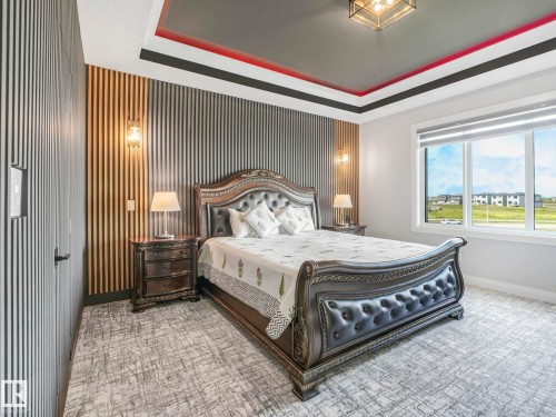 Carpeted bedroom featuring a raised ceiling and baseboards - 15 Elwyck Gate, Spruce Grove, AB - Indoor Photo Showing Bedroom