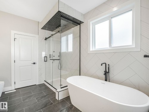 Bathroom with a freestanding tub, a shower stall, and tile walls - 15 Elwyck Gate, Spruce Grove, AB - Indoor Photo Showing Bathroom