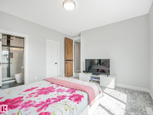 Bedroom featuring baseboards and ensuite bath - 15 Elwyck Gate, Spruce Grove, AB - Indoor Photo Showing Bedroom