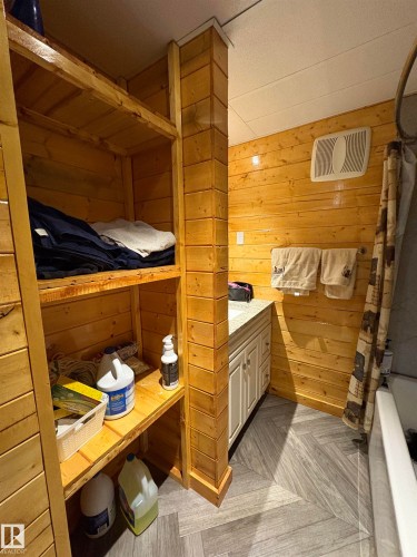 Bathroom featuring wood walls, vanity, and shower / tub combo - B58018 Hiway 29, Rural St. Paul County, AB - Indoor