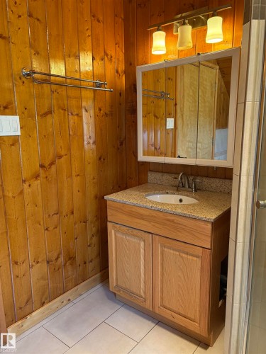 Bathroom with wooden walls, vanity, and tile patterned floors - B58018 Hiway 29, Rural St. Paul County, AB - Indoor Photo Showing Bathroom