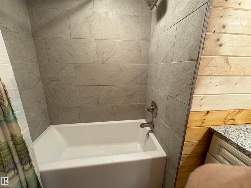 Bathroom with shower / bath combination with curtain and vanity on lower level - B58018 Hiway 29, Rural St. Paul County, AB - Indoor Photo Showing Bathroom