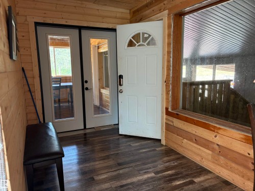 Foyer featuring wood walls and dark wood finished floors - B58018 Hiway 29, Rural St. Paul County, AB - Indoor Photo Showing Other Room