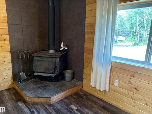 Corner fireplace in kitchen - B58018 Hiway 29, Rural St. Paul County, AB - Indoor Photo Showing Other Room With Fireplace