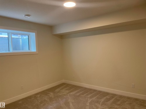 Below grade area featuring baseboards and carpet floors - 4112 Ginsburg Place, Edmonton, AB - Indoor Photo Showing Other Room