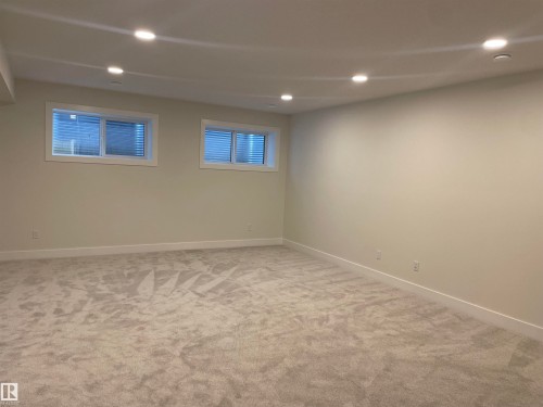 Basement with light colored carpet and recessed lighting - 4112 Ginsburg Place, Edmonton, AB - Indoor Photo Showing Basement