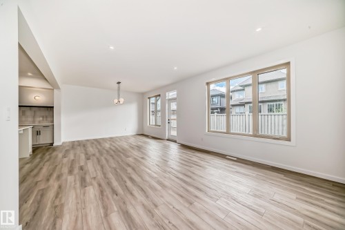 Unfurnished living room featuring light wood-style flooring and recessed lighting - 1401 Ainslie Wynd, Edmonton, AB - Indoor
